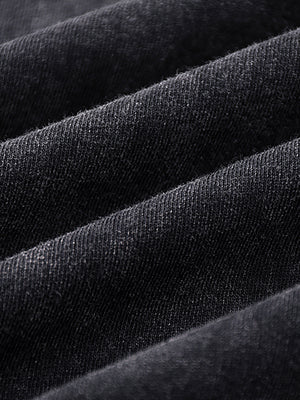 Folds of the snow-washed black cotton jersey of the Tiger Tank Top Y2K, showing its faded tone