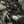 The camo fabric twisted to show its texture, a 340 gsm woven cotton of moderate thickness