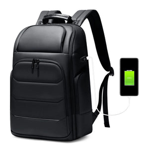 Black hardshell backpack with an external USB charging port and a 17 inch laptop sleeve