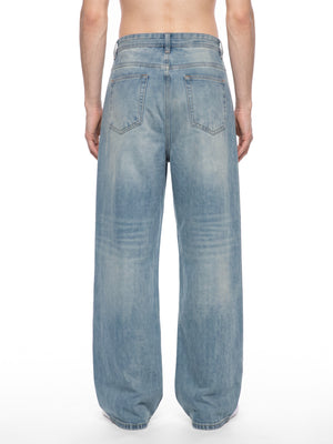 Model seen from behind in the vintage wash baggy jeans, relaxed seat and wide legs over white socks