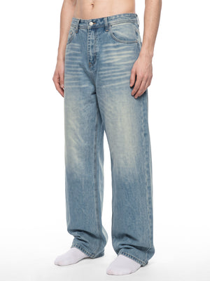 Three quarter view of the vintage wash baggy jeans on a model, front pockets, whiskering and loose fit