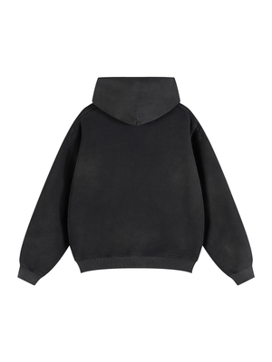 The black hoodie photographed at an angle, hood settled, showing the short boxy silhouette