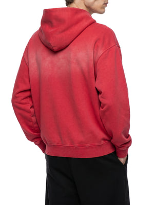 A model seen from behind in the red colourway, the hem finishing square across the back