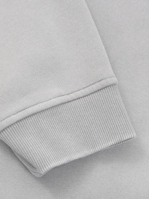 Close-up of the ribbed cuff, knitted tight so the sleeve holds at the wrist