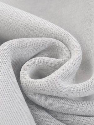 The fleece twisted to show its texture, a 355 gsm blend with a soft brushed inside