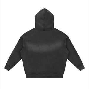 Back of the black hoodie laid flat, plain, the wash leaving the shoulders lighter than the hem