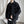 Black Washed Denim Y2K Jacket worn open over a black tee and chain necklace, front view by a white curtain