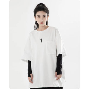 White dress with black sleeves and a small black logo worn by a model on a white background