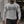 Flecking gray colourway on a man walking outside a gym, the black root lettering across the chest