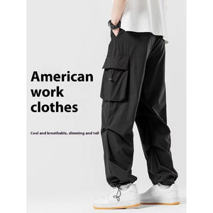 Svart färgvariant med en textbanner som lyder American work clothes bredvid modellen, vida ben och fickor med lock