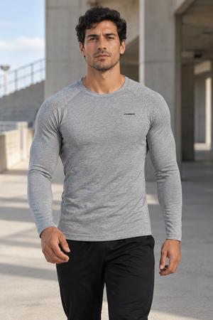 Man walking in the Flecking Gray long sleeve compression shirt, front view of the raglan sleeves and crew neck