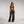 Zip Denim Y2K Overalls in washed black, front view with the front zip open over a black bandeau