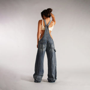 Zip Denim Y2K Overalls in mid blue, back view showing the shoulder straps and the rear pockets