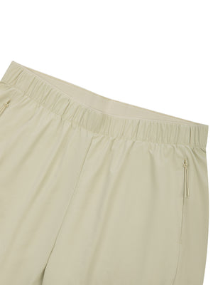 Close-up of the Bean Green shorts waistband, flat elastic band and the top of the zip pocket