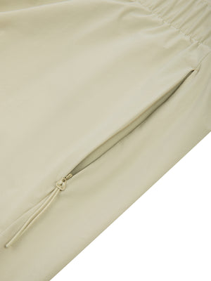 Detail of the zip pocket on the Bean Green basketball shorts, tonal zipper with a pull cord