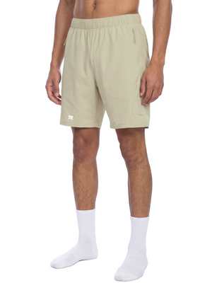 Bean Green basketball shorts in three-quarter front view on a model, zip pockets on both sides