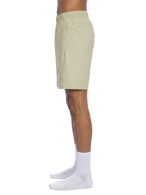 Side view of the Bean Green basketball shorts on a model, straight leg ending just above the knee