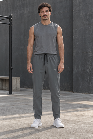 Man in Gray Zip Pocket Gym Sweatpants and a gray tank top, front view with black drawstring outdoors