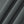 Close-up of the Gray polyester and spandex fabric of the zip pocket gym joggers, fine knit texture