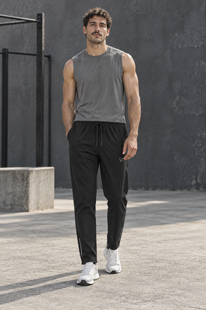 Black zip pocket gym joggers worn front walking view, drawstring waist and white sneakers outdoors