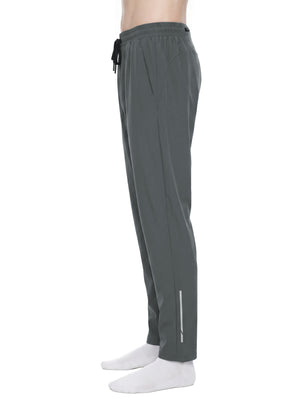 Side view of the Gray joggers on a model, drawstring hanging and thin silver-tone strip near the ankle