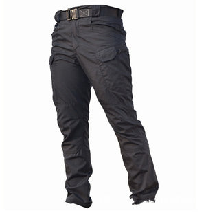 Black tactical cyberpunk pants shown alone on a white background, three-quarter front view with belt loops