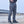Gray Zip Pocket Tactical Cyberpunk Pants seen from the front, hands on the belt, straight leg down to black shoes