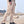 Khaki cyberpunk pants on a man walking, side view of the thigh cargo pocket and the belt loops at the waistband