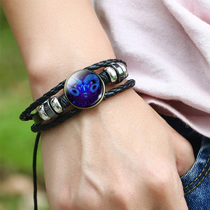 Zodiac Glow Y2K Bracelet worn on the wrist, close-up of the domed Aries cabochon and loose cord ends