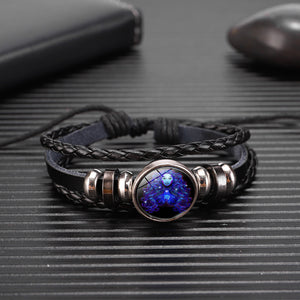 Zodiac Glow Y2K Bracelet lying on a ribbed dark surface, domed cabochon between silver-tone beads